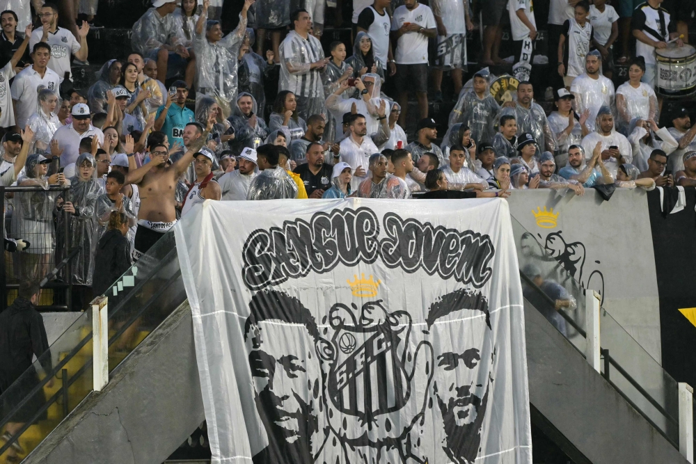 Santos' fans display a banner with the images of Brazilian football players Pele and Neymar as they await the arrival of football star Neymar before his presentation as a new player of the Santos football team at the Urbano Caldeira Stadium in Santos, Sao Paulo state, Brazil on January 31, 2025. — AFP pic