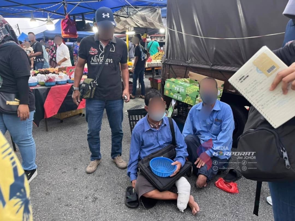 A pair of disabled foreigners nabbed by Johor Immigration Department officers at a night market in Taman Ahad in Johor Baru yesterday, February 5, 2025. — Picture courtesy of the Johor Immigration Department 