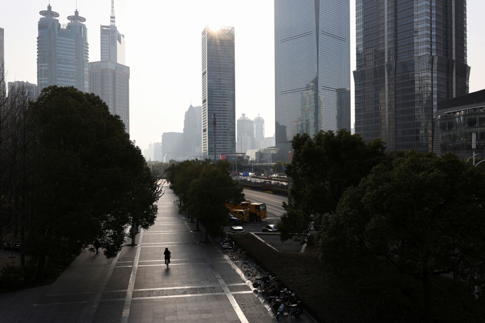 A person rides a bicycle in the Pudong financial district after Lunar New Year holiday in Shanghai, China, February 5, 2025. — Reuters pic