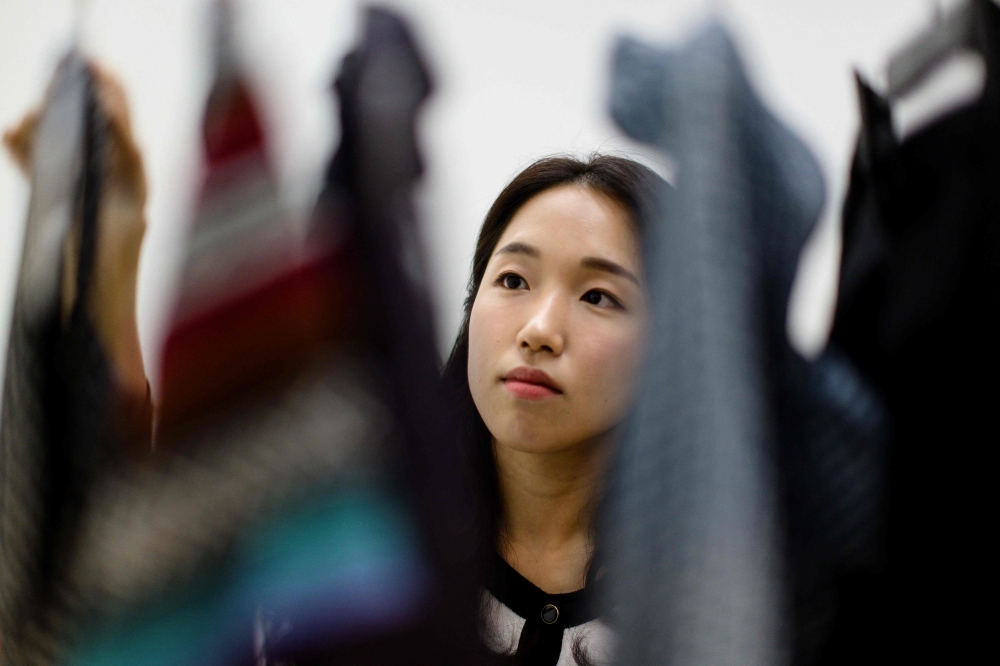 Recovering South Korean shopaholic turned climate activist Lee So-yeon used to buy new clothes almost every day -- until a US$1.50 winter coat triggered an awakening that stopped her shopping entirely. — AFP pic