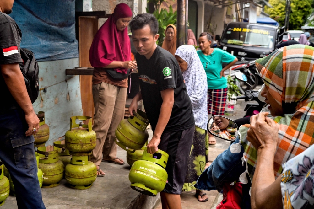 People line up at a store selling cooking gas in Jakarta on February 5, 2025. — AFP pic