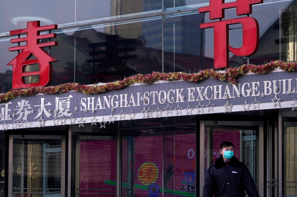 A security guard stands at the Shanghai Stock Exchange building at the Pudong financial district in Shanghai, China. February 3, 2020. — Reuters pic