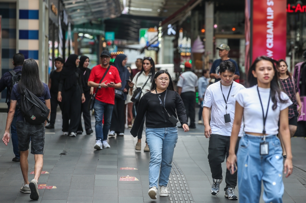 File picture of people walking around Bukit Bintang, Kuala Lumpur. The Ministry of Communications has undertaken a realignment of the functions and vision of the Department of Community Communications (J-Kom), emphasising inclusive and effective communication strategies that appreciate societal diversity. — Picture by Yusof Mat Isa