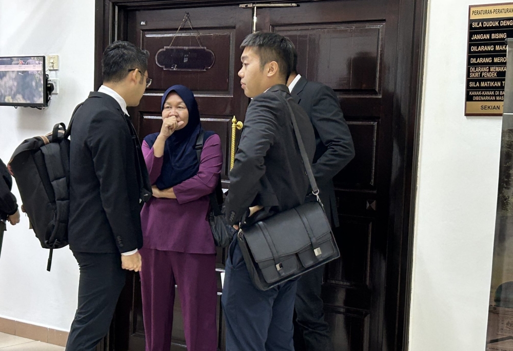 Sunaty speaks with her lawyers after being sentenced for violating Section 37(1) of the Wild Life Protection Ordinance 1998 at the Kuching Court Complex on February 6, 2025. — The Borneo Post pic