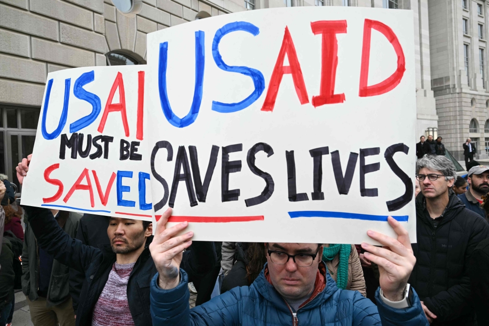 People protest outside of the headquarters for United States Agency for International Development (USAID), before Congressional Democrats hold news conference in Washington, DC, on February 3, 2025. — AFP pic