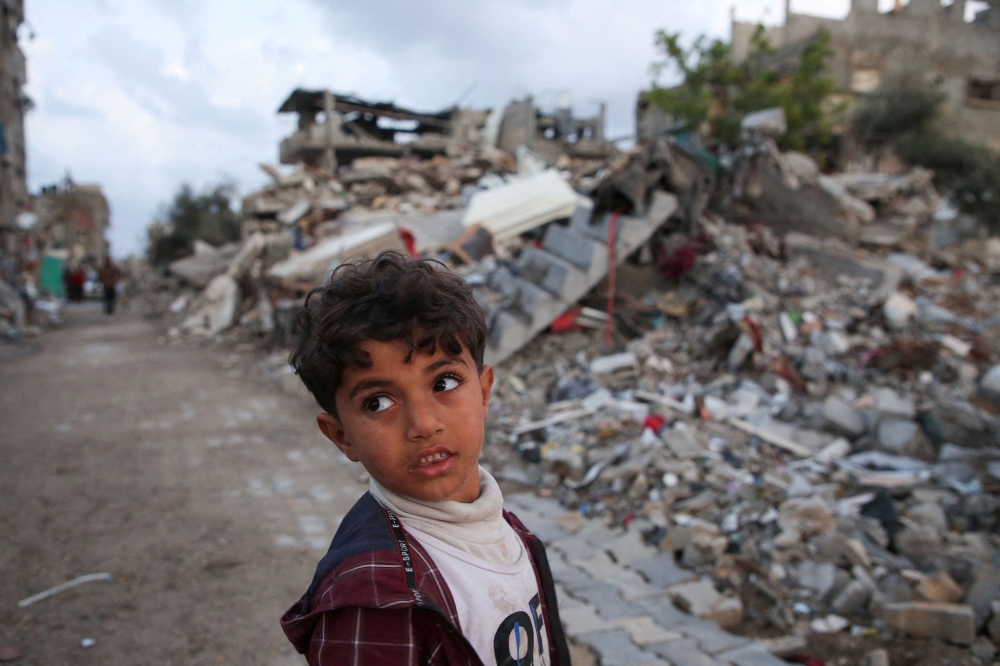 A Palestinian child looks on, near the rubble of a building destroyed during the Israeli offensive, amid a ceasefire between Israel and Hamas, in Rafah, in the southern Gaza Strip, February 5, 2025. — Reuters pic