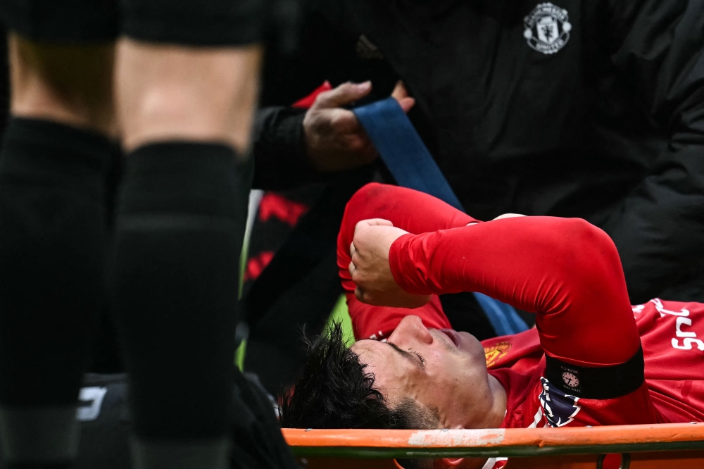 Manchester United’s Lisandro Martinez reacts as he is placed on a stretcher following an injury during the English Premier League match with Crystal Palace at Old Trafford in Manchester February 2, 2025. — AFP pic