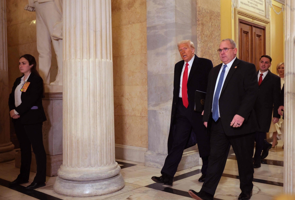 US President Donald Trump arrives at the National Prayer Breakfast in the US Capitol yesterday. — AFP pic