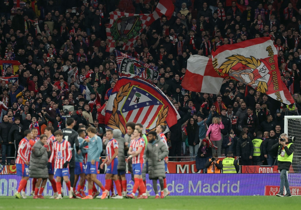 Atletico Madrid fans celebrate their team's victory at the end of the Spanish Copa del Rey (King's Cup) quarter-final first leg football match between Club Atletico de Madrid and Getafe CF at Metropolitano Stadium in Madrid on February 4, 2025. — AFP pic