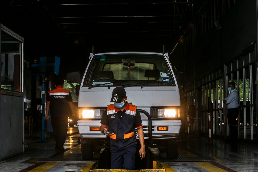 Puspakom staff inspect commercial vehicles at its Wangsa Maju branch in Kuala Lumpur August 8, 2022. — File picture by Hari Anggara