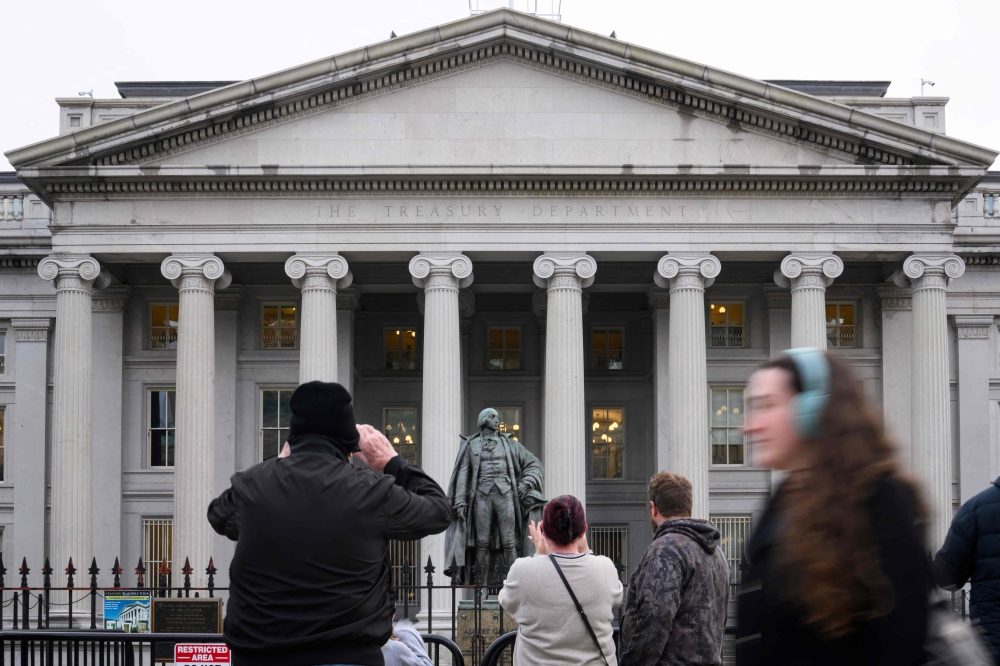 People take pictures of the US Treasury in Washington, DC, on February 6, 2025. — AFP pic