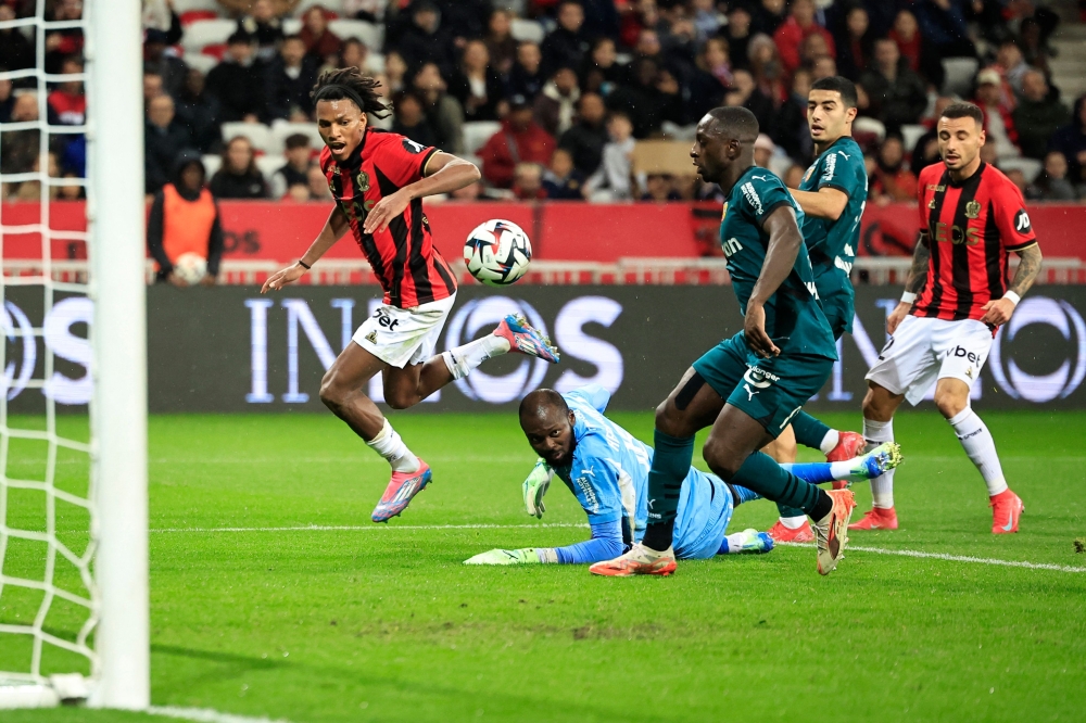 Lens goalkeeper Herve Koffi watches the ball as Nice’s Algerian Hicham Boudaoui shoots — Pic by AFP
