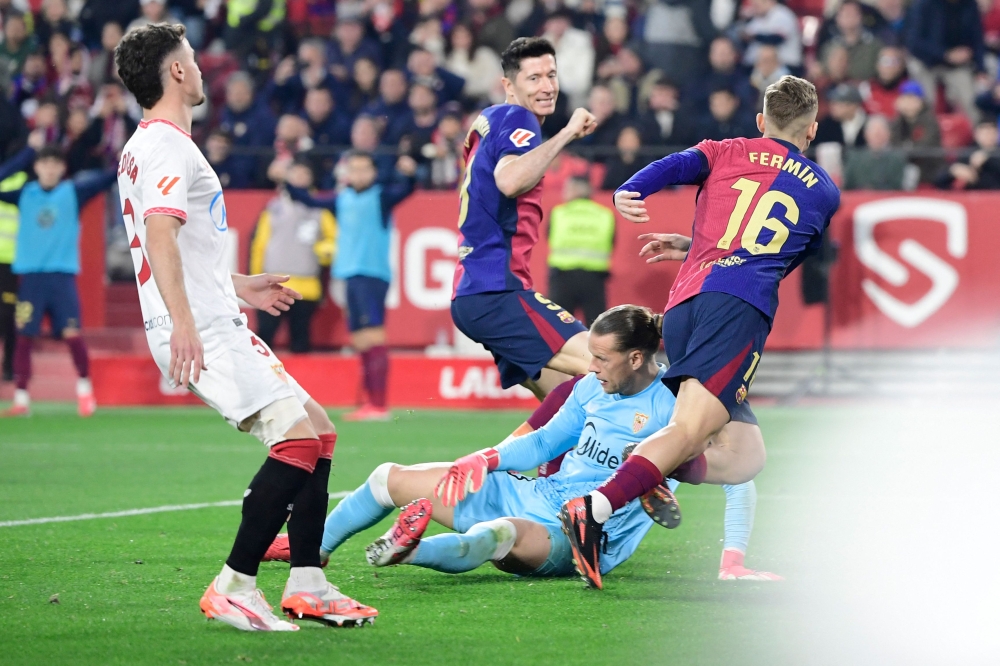 Barcelona’s Spanish midfielder #16 Fermin Lopez celebrates after scoring his team’s second goal during the Spanish league football match between Sevilla FC and FC Barcelona at Ramon Sanchez Pizjuan Stadium in Seville on February 9, 2025. — AFP pic