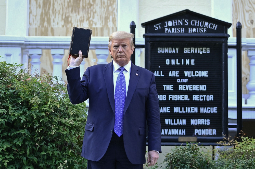 US President Donald Trump holds up a Bible outside of St John's Episcopal church across Lafayette Park in Washington, DC on June 1, 2020. — AFP file pic