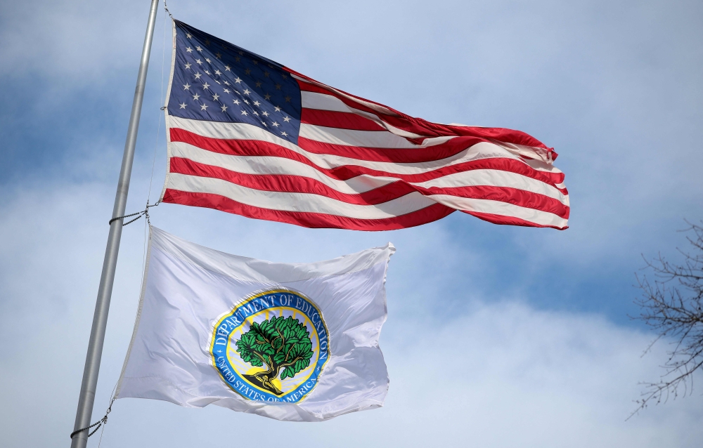 Flags fly over the Lyndon Baines Johnson Department of Education Building in Washington, DC while US President Donald Trump signals his intent to abolish the federal agency by executive order in 2025. — AFP pic