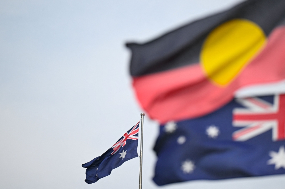 An Aboriginal flag flies alongside the Australian flag as the Albanese government acknowledges the ongoing struggles faced by the nation’s Indigenous people. — Reuters file pic