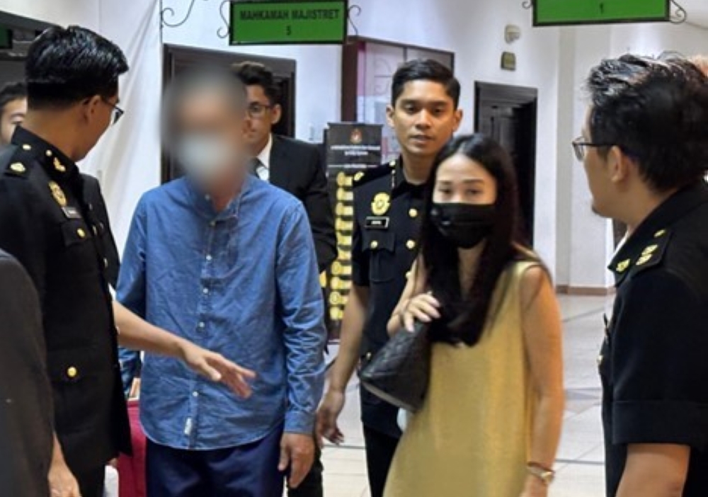 One of the businessmen leaves the courtroom following proceedings today. — The Borneo Post pic