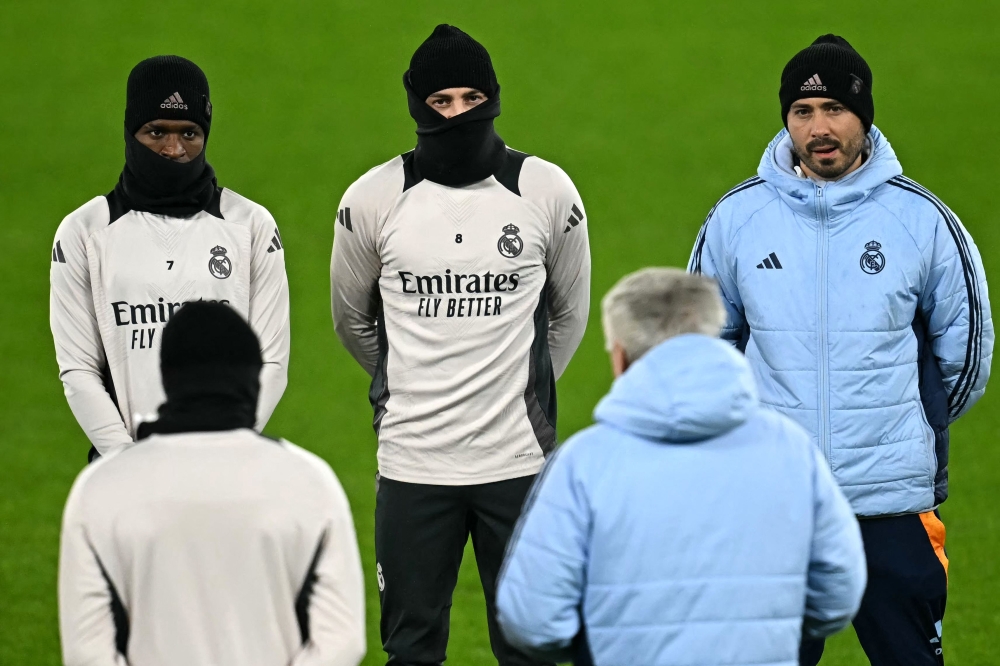 Real Madrid's Brazilian forward #07 Vinicius Junior (left) Real Madrid's Uruguayan midfielder #08 Federico Valverde (centre) and Real Madrid's Italian assistant coach Davide Ancelotti look on during and a training session at the Ethiad Stadium in Manchester on the eve of their UEFA Champions League football match against Manchester City. — AFP pic