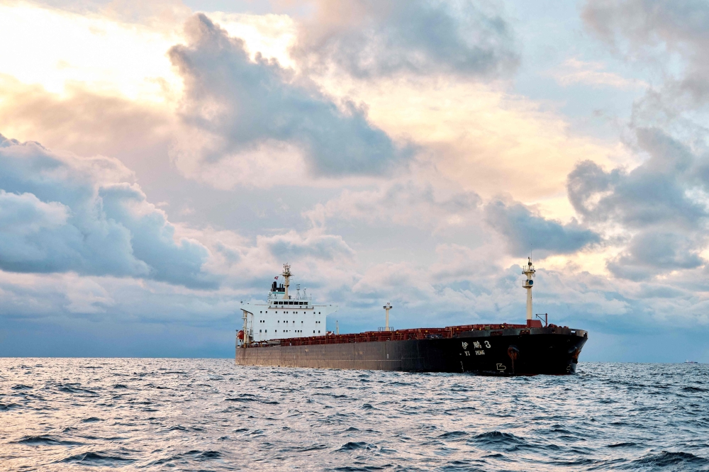 A bulk carrier is monitored by a Danish naval patrol vessel (unseen) in the sea of Kattegat, near the City og Granaa in Jutland, Denmark, on November 20, 2024. — AFP pic 