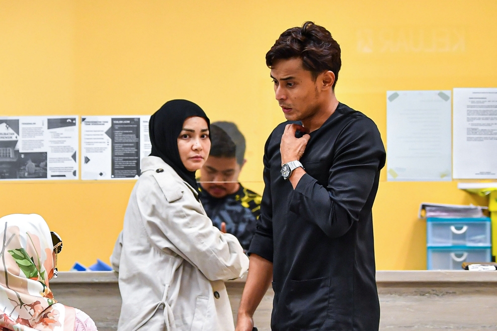 Actress Ayu Raudhah (left) and her husband, former national footballer Mohamad Zaquan Adha, grieve the death of their seventh and youngest child Muhammad Aisy Al Rees at age six months, on February 11, 2025. — Bernama pic