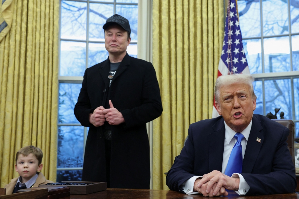 US President Donald Trump speaks next to Elon Musk and X Æ A-12, Musk's son, in the Oval Office of the White House in Washington, DC, U.S., February 11, 2025. — Reuters pic