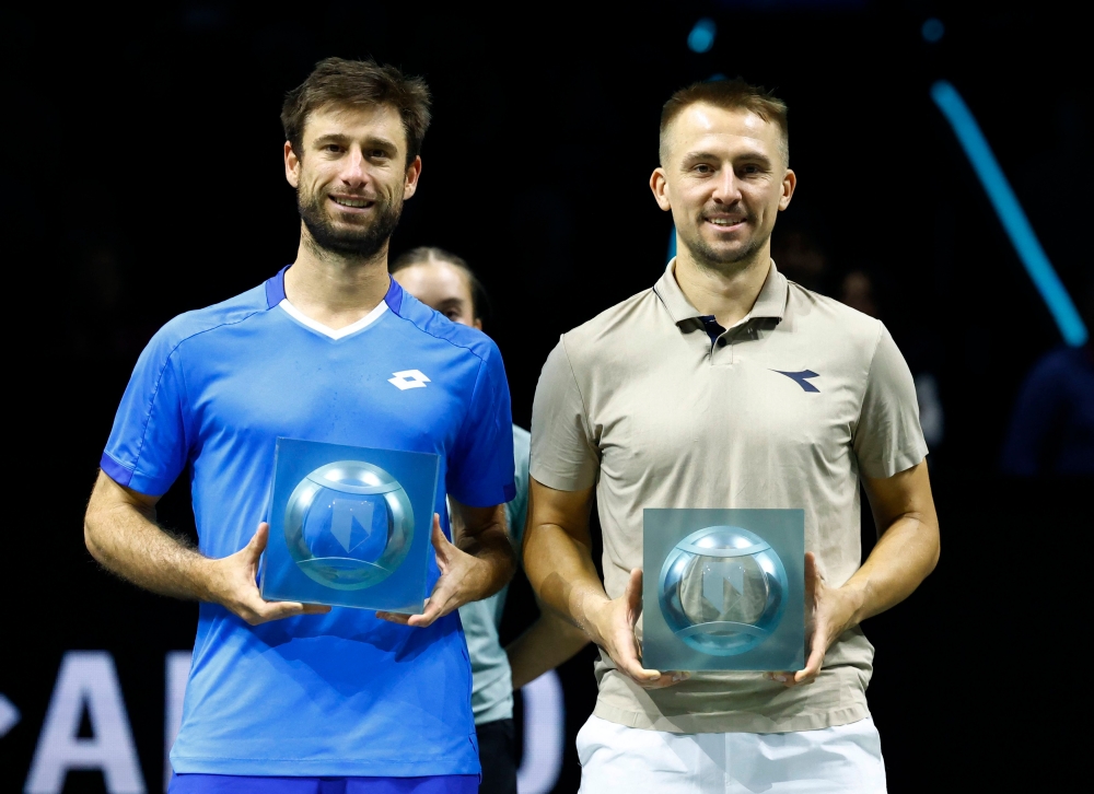 Poland’s Jan Zielinski (right) and Belgium’s Sander Gille (left) pose with their runners-up trophies after losing their doubles final match against Italy’s Simone Bolelli and Italy’s Andrea Vavassori at the Rotterdam Open in the Netherlands on February 9, 2025. — Reuters pic
