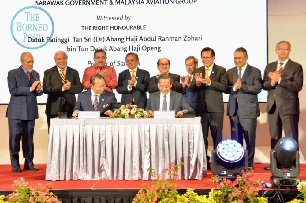 Transport Minister Anthony Loke, Abang Johari and others witness the signing of the SPA in Kuching today. — The Borneo Post pic