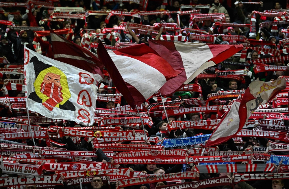 Bayern fans wave banners and hold scarves during the UEFA Champions League play-off first leg football match between Celtic and Bayern Munich at Celtic Park stadium in Glasgow, Scotland on February 12, 2025. — AFP pic