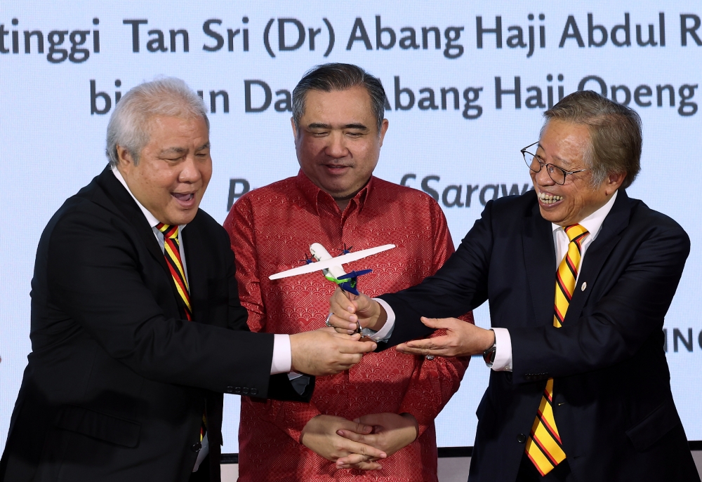 Sarawak Premier Tan Sri Abang Johari Openg and Transport Minister Anthony Loke look at an aircraft model after witnessing the agreement exchange between the Sarawak government and Malaysia Aviation Group (MAG) in Kuching February 12, 2025. — Bernama pic