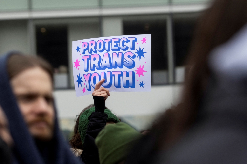 A pro-trans rights demonstrator holds a sign at a Rise Up for Trans Youth! event in New York City, U.S., February 8, 2025. — Reuters pic