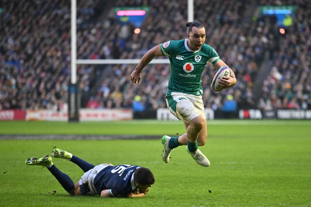 Ireland’s wing James Lowe (right) skips away from Scotland’s full-back Blair Kinghorn (left) on his way to scoring a try during the Six Nations international rugby union match between Scotland and Ireland at Murrayfield Stadium in Edinburgh, Scotland on February 9, 2025. — AFP pic