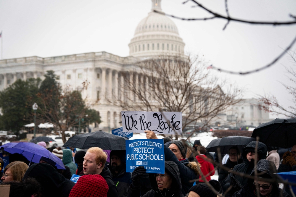 People protest outside the US Capitol on February 12, 2025 in Washington, DC, highlighting recent actions by Elon Musk’s Department of Government Efficiency (DOGE) that possibly threatens both educational research and student privacy. — AFP pic