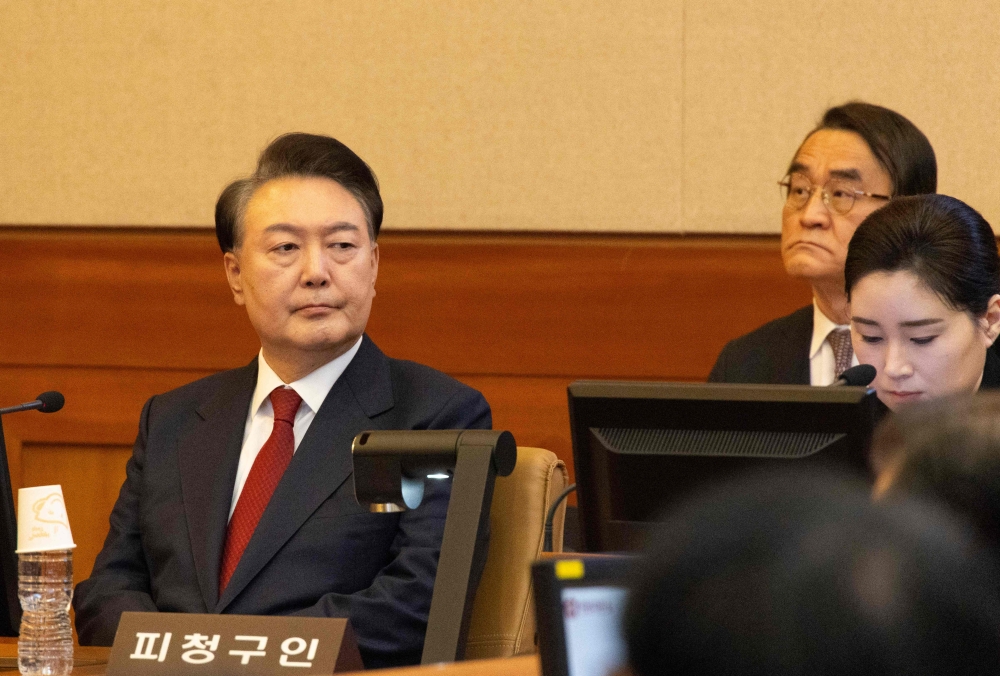 South Korean President Yoon Suk Yeol (left) attends a hearing of his impeachment trial at the Constitutional Court in Seoul on February 13, 2025. — AFP pic