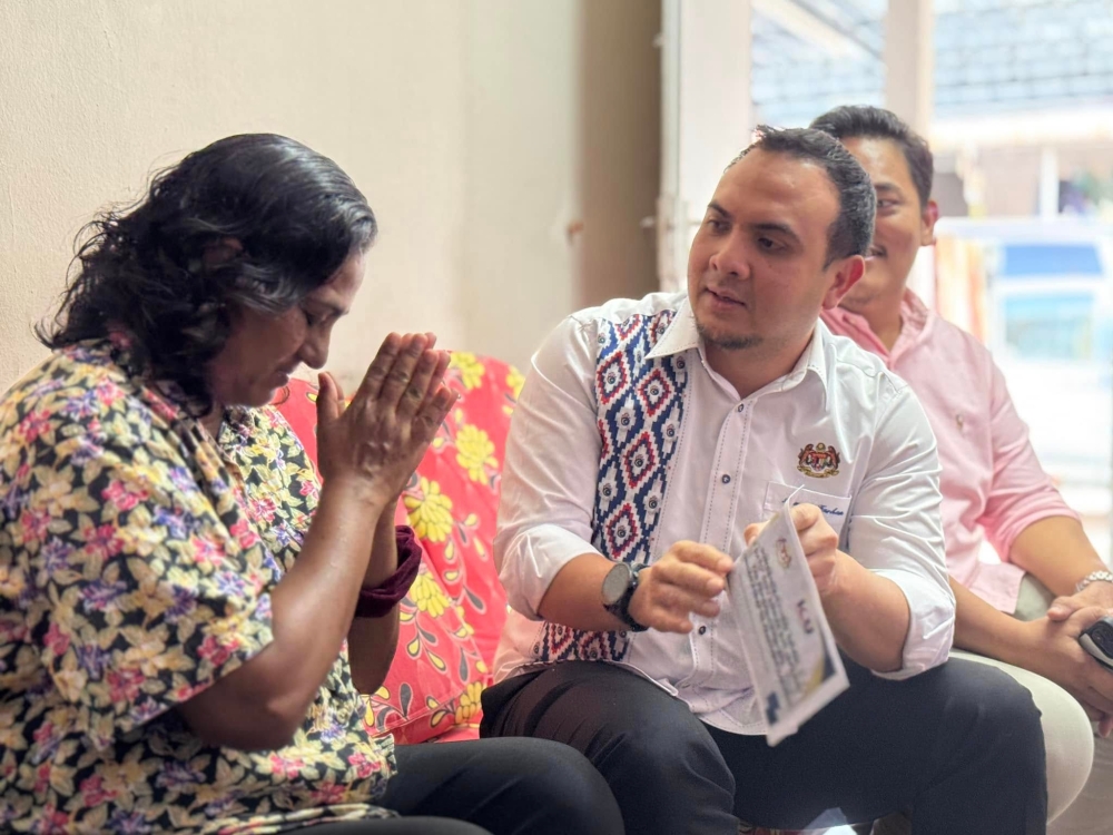 The prime minister’s political secretary, Datuk Ahmad Farhan Fauzi, visits an aid recipient during the Ziarah Madani programme in Tambun February 13, 2025. — Picture via Facebook