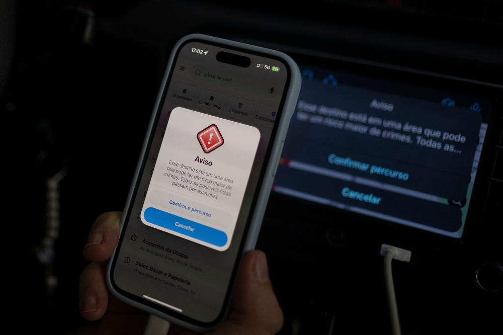 A warning on the Waze app saying “This destination is in an area that may have a higher risk of crime” is displayed on the smartphone of an Uber driver in Rio de Janeiro, Brazil on February 12, 2025. — AFP pic