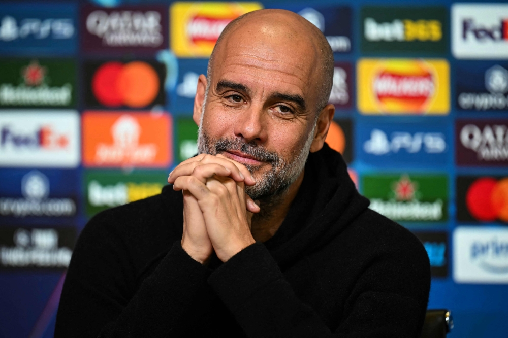 Pep Guardiola taunted Premier League leaders Liverpool over their failure to match Manchester City’s record 100-point tally. — Pic by AFP