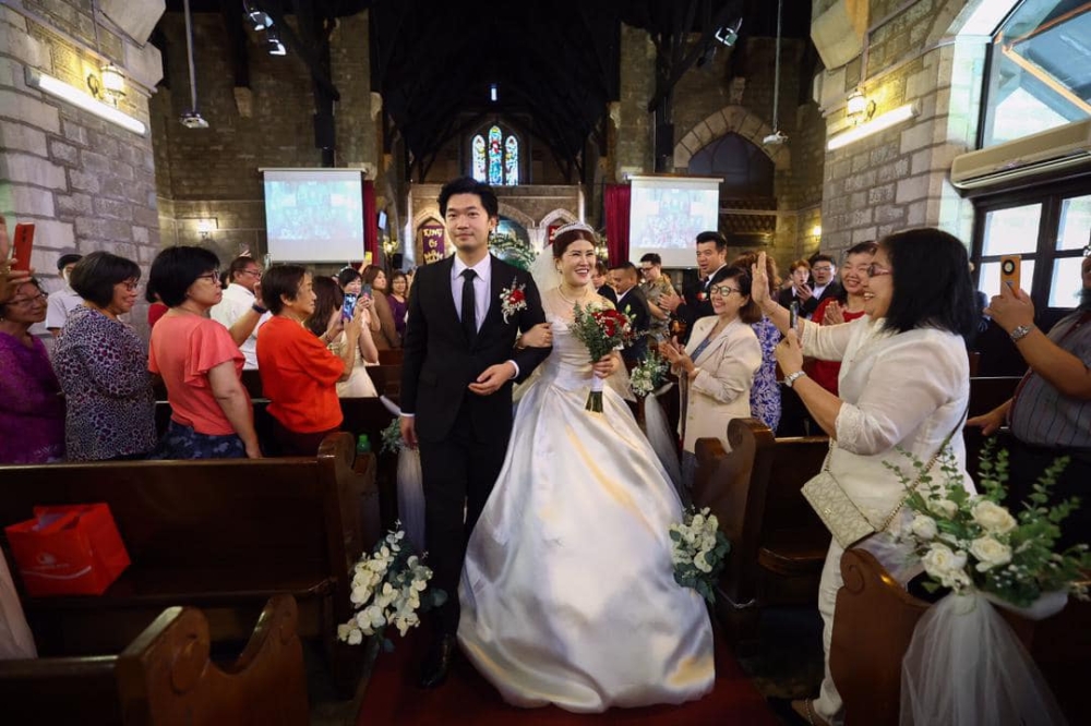 Sandakan MP Vivian Wong and Lue King Chiew leave St Michael’s Anglican Church in Sandakan February 14, 2025, after their wedding ceremony. — Picture via Facebook