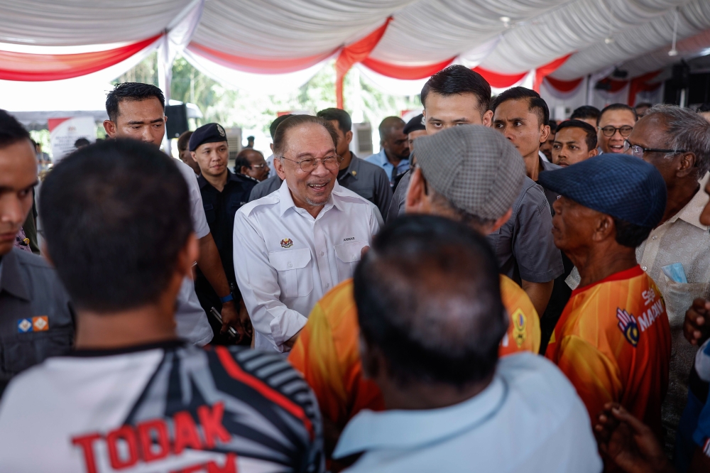 Prime Minister Datuk Seri Anwar Ibrahim greets members of the public during the groundbreaking ceremony for the Harmoni Madani Bestari Jaya People’s Housing Programme (PPR) in Tanjung Karang February 15, 2025. — Bernama pic