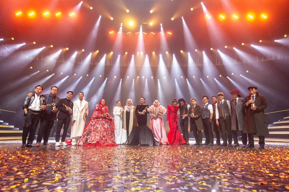 Marsha Milan (centre) celebrates with fellow winners and finalists of Anugerah Juara Lagu 2025 on stage after the awards ceremony onFebruary 16, 2025. — Picture by Raymond Manuel