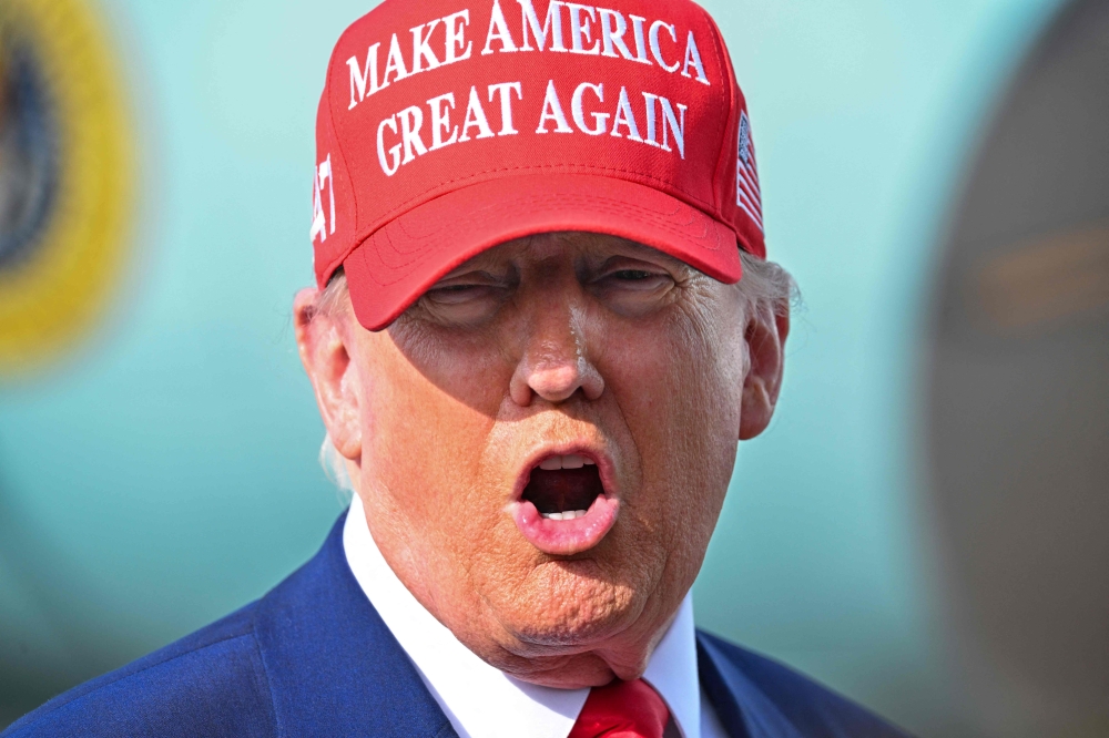 US President Donald Trump speaks to reporters after landing at the Palm Beach International Airport in West Palm Beach, Florida on February 16, 2025 after attending the Daytona 500 car race earlier in the day. — AFP pic 