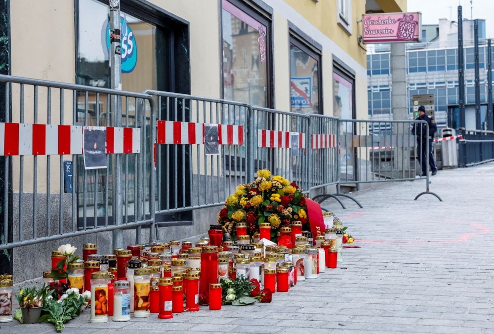 Candles and flowers sit at the scene where a 14-year-old boy was killed and several others were wounded in a stabbing attack, in the town of Villach, Austria February 16, 2025. — Reuters pic 