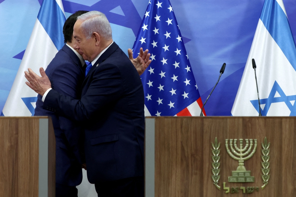 US Secretary of State Marco Rubio and Israeli Prime Minister Benjamin Netanyahu embrace during a handshake as they make joint statements to the press at the Prime Minister’s office in Jerusalem, February 16, 2025. — Reuters pic 