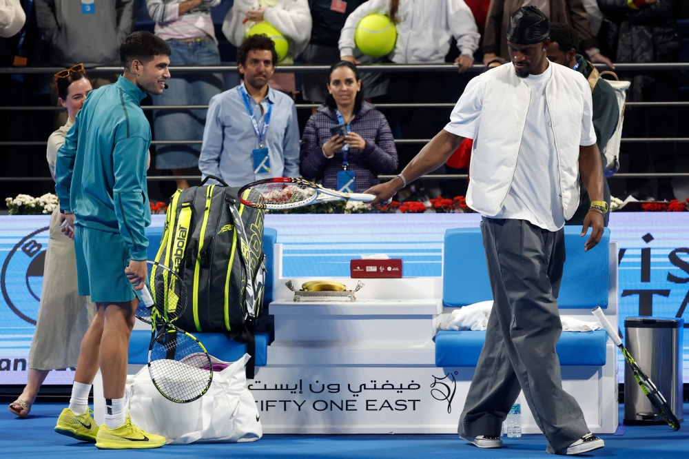 Jimmy Butler of the Golden State Warriors jokes with Spain’s Carlos Alcaraz after his men’s singles match at the ATP Qatar Open tennis tournament in Doha February 17, 2025. — AFP pic