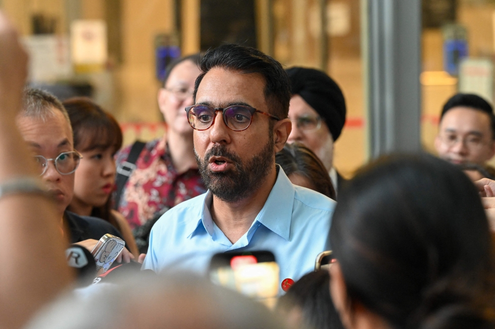 Pritam Singh, secretary-general of the opposition Workers’ Party, speaks to reporters after the verdict in his trial at the State court in Singapore on February 17, 2025. — AFP pic