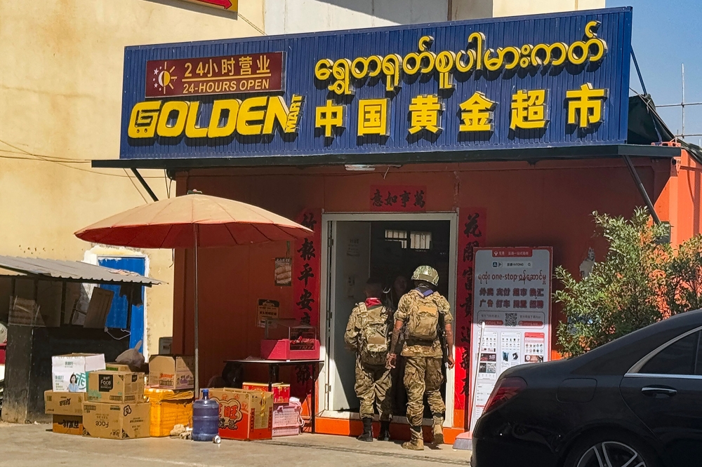 Members of the Karen Border Guard Force (BGF) carry out an inspection at a work place during a crackdown operation on illicit activity linked to scam centres in Shwe Kokko in Myanmar’s eastern Myawaddy township on February 14, 2025. — AFP pic 