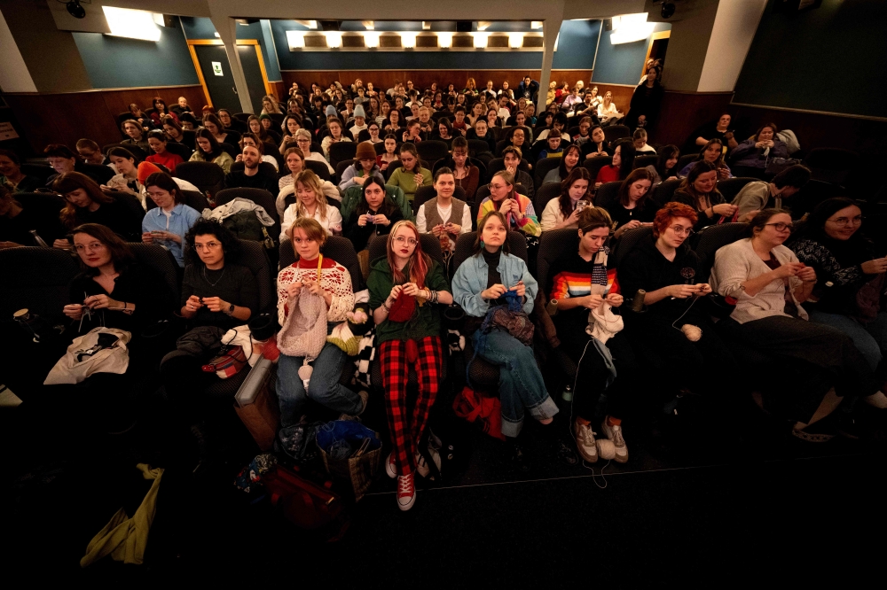 This general overview shhow visitors enjoying their knitting during the projection of the movie ‘The Devil Wears Prada’ at the Votive Cinema in Vienna February 16, 2025. — AFP pic
