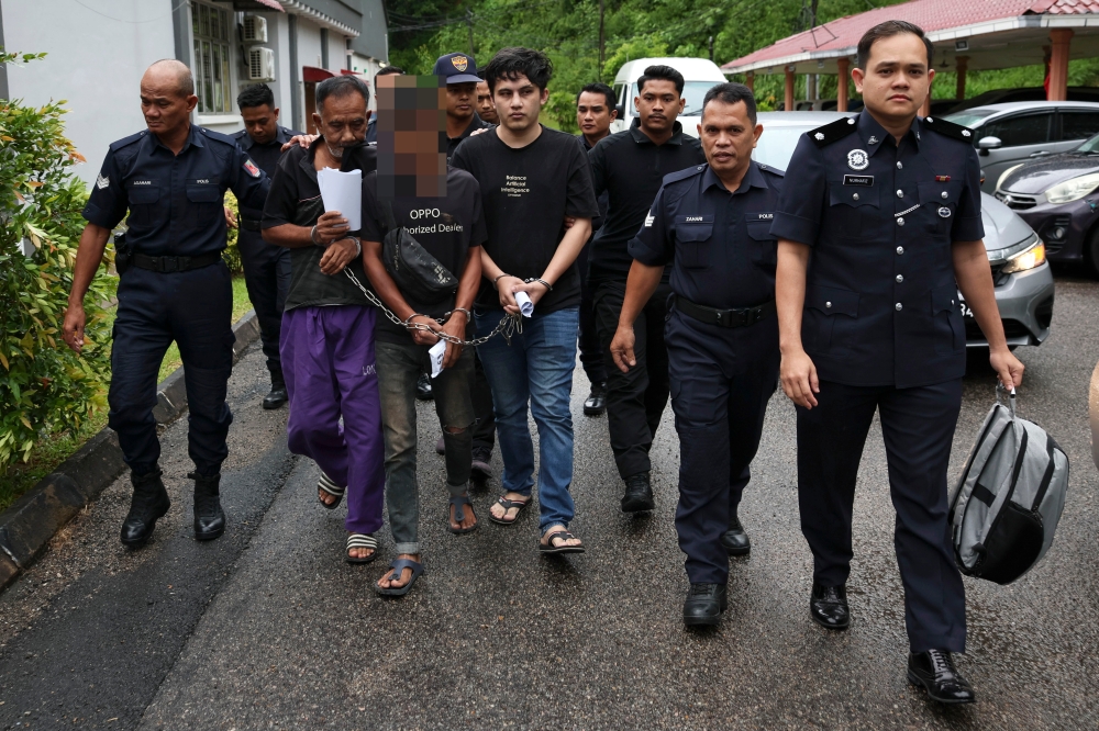 Mohamed Ismail, 68, (third from left) and Muhammad Amir Ikram Mohd Dzulkiflee, 32, (fifth from right) at the Bentong Magistrate’s Court today, where they were charged with trafficking 275.19kg of drugs on February 6. — Bernama pic