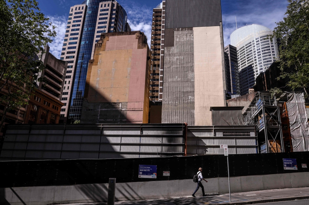 A pedestrian walks past a construction site in the central business district of Sydney on February 18, 2025. — AFP pic