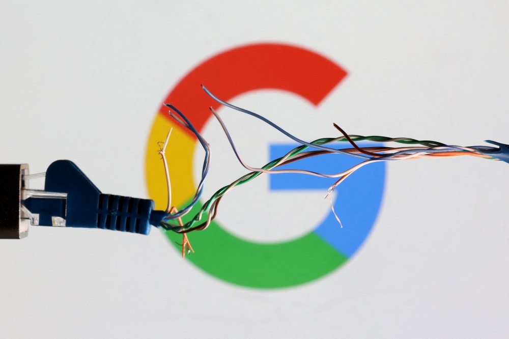 Broken Ethernet cable is seen in front of Google logo in this illustration taken March 11, 2022. — Reuters pic