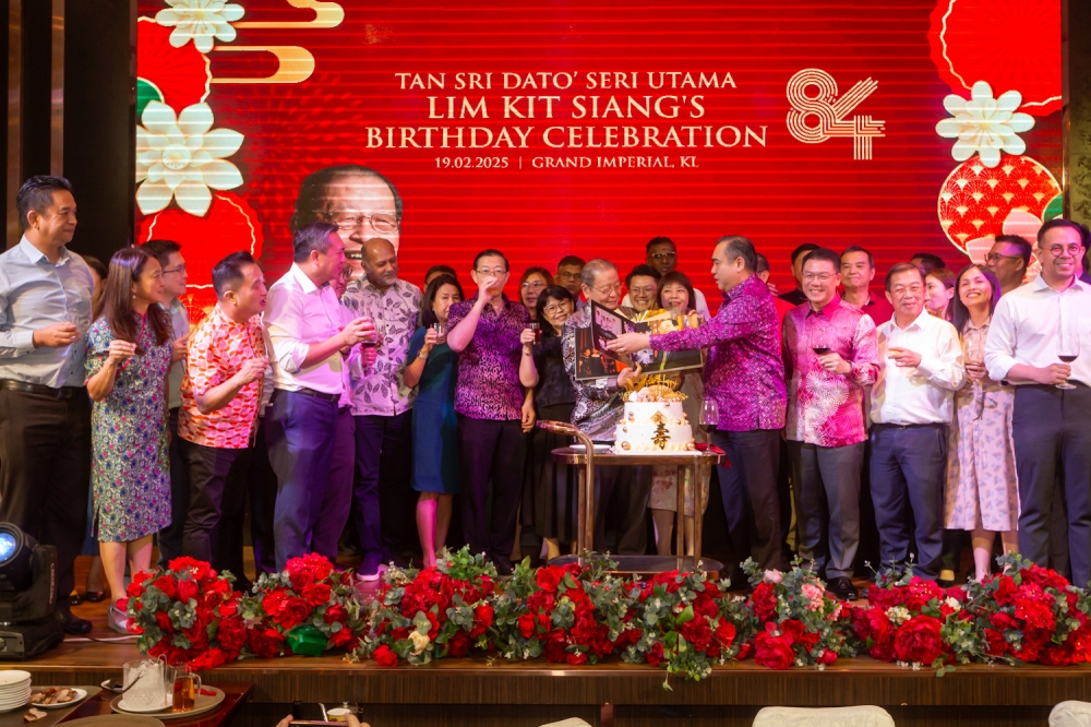 DAP secretary-general Anthony Loke (fifth from right) announced that the party will start a new custom of holding a DAP “family reunion” on Tan Sri Lim Kit Siang’s (centre, holding book) birthday every year from now on. — Picture By Raymond Manuel